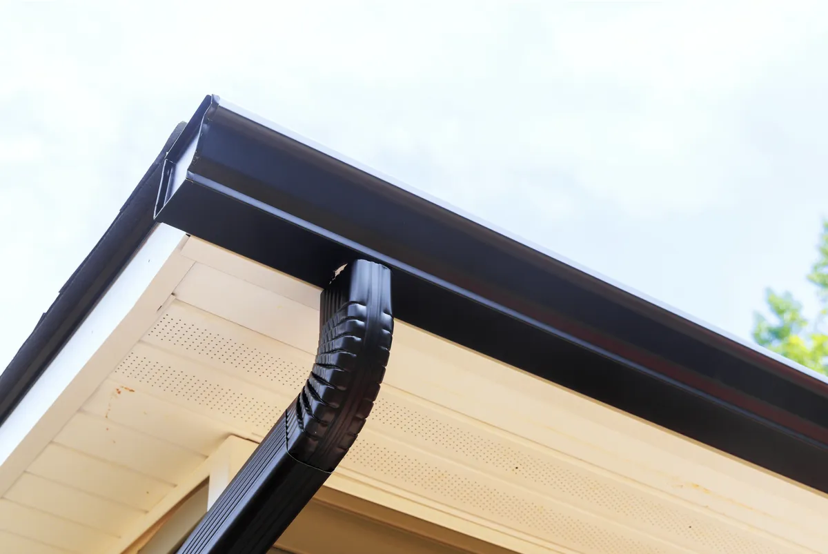 Black aluminum downspout installed on a Yonkers residential property