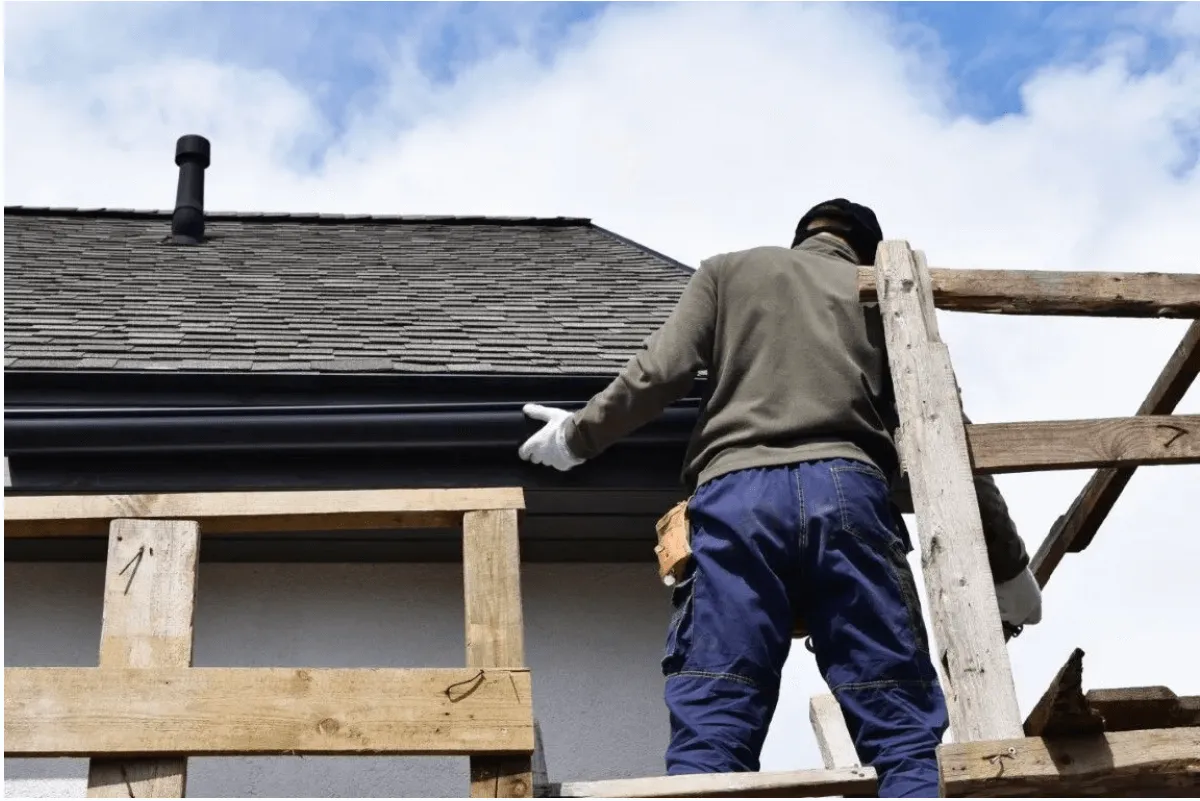 Gutter guard system catching sunlight on a Yonkers home roofline
